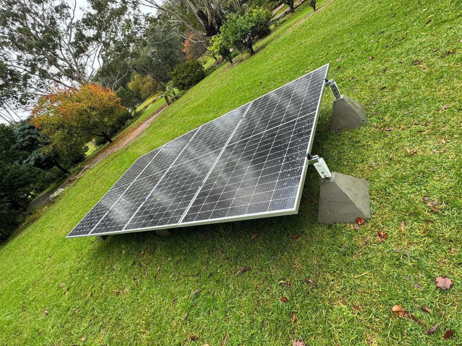 Ground-mounted solar array installed on a lawn